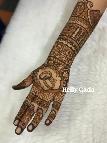 A full view of the hand with the engagement ring design. The intricate patterns on the arm and fingers complement the central motif, creating a complete and elegant look.