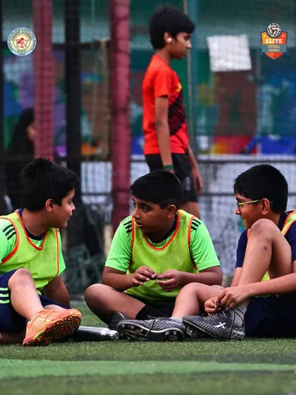 Young players in a discussion during a break. Learning the game involves strategy and communication.