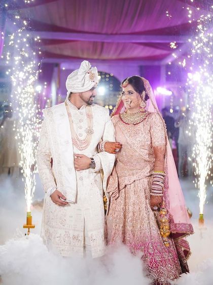 A fairytale entry for this couple. The bride's pastel lehenga looks magical with the smoke and sparklers.