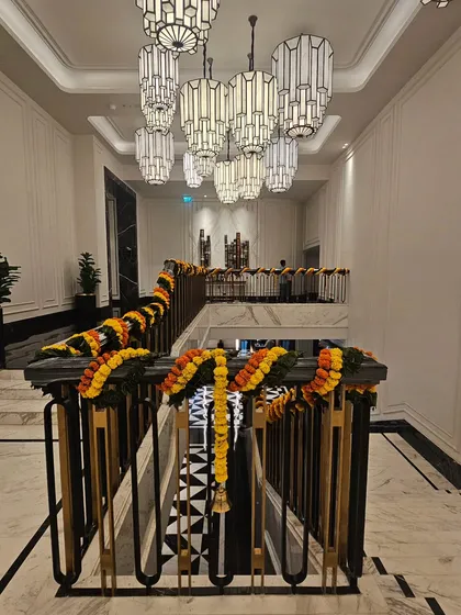 For the same project at Fairmont Mumbai, I extended the festive theme to other areas. Here you can see the staircase railing adorned with thick marigold garlands, creating a continuous and welcoming festive journey for guests.