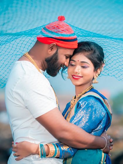 An intimate embrace under a fishing net. This photo uses a key element of Koli life as a creative prop, framing the couple in a tender moment that is both artistic and culturally significant.