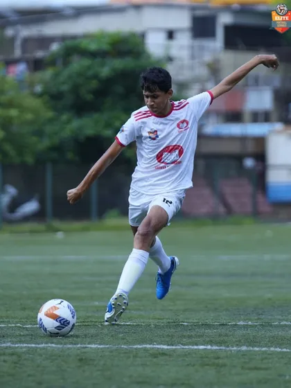 A player strikes the ball with perfect form, a moment of individual skill contributing to the team's effort.