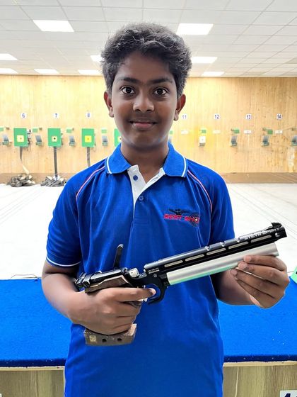 Ashwanth, a bronze medalist in the Under-14 boys' category, posing with his air pistol.