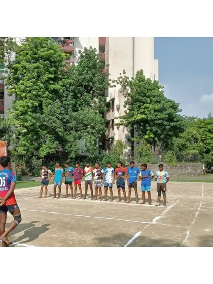 Our sub-junior team lined up on the mud court before their championship match in Gazipur.