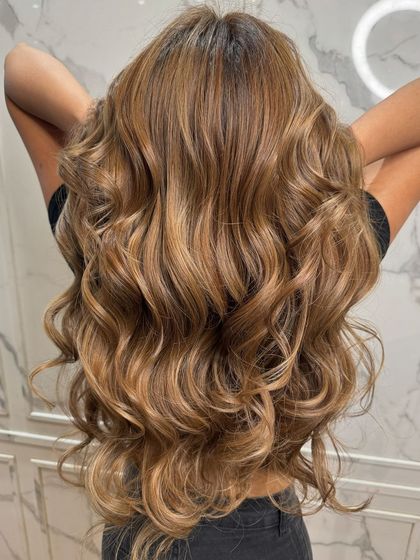A beautiful balayage with soft, flowing waves that showcase the color's dimension.