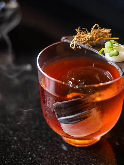 Shaken, stirred, and always sophisticated. This is our Kozhikode Negroni, captured with its signature smoke, a perfect example of mixology magic in a glass.