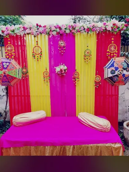 A classic seating arrangement for a Mehandi ceremony. I provide a decorated backdrop with traditional Rajasthani umbrellas and a comfortable mattress with bolsters for the main rituals.