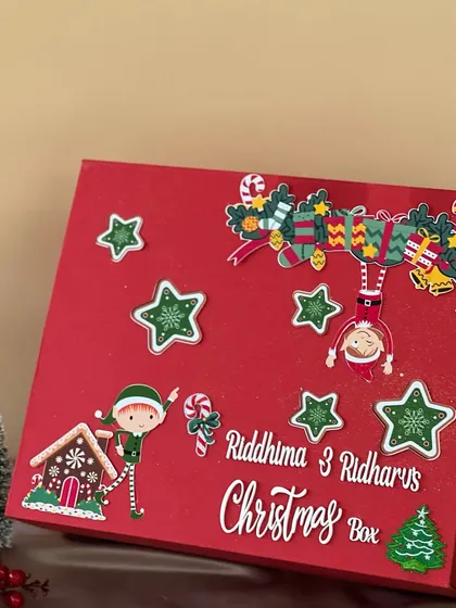 A personalized Christmas box for siblings, decorated with cute elf and gingerbread house stickers. It’s the perfect way to make the holiday season even more special for them.