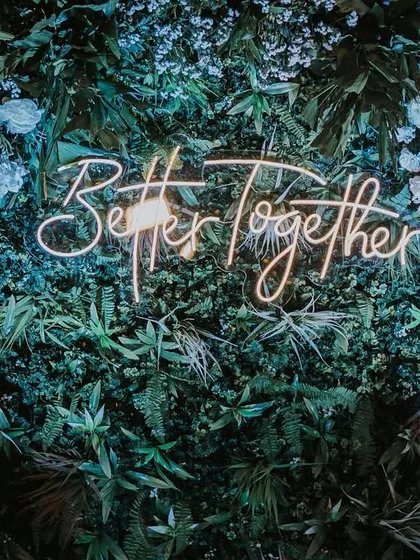 The right decor sets the mood for your entire event. A custom neon sign against a lush green wall is a modern, chic way to personalize your space and create a stunning photo backdrop for your reception or cocktail party.