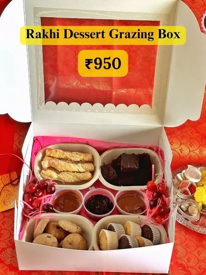 The Rakhi Dessert Grazing Box is a modern twist on festive gifting. It’s a curated assortment of sweet and savoury bites, including mini cupcakes, cookies, brownies, and dips, perfect for sharing and celebrating the sibling bond.
