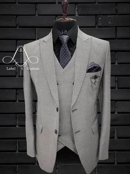 Sleek, stylish, and sophisticated. A grey suit is a perfect addition to your wardrobe. This light grey patterned three-piece is a classic that never goes wrong.