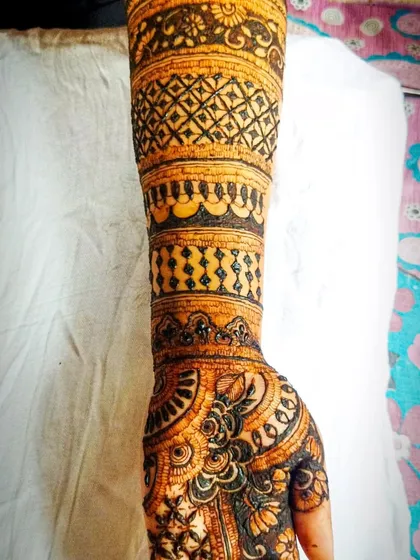 A close-up shot of the forearm, highlighting the different types of filler patterns used. You can see the precision in the checkered, striped, and dotted sections.
