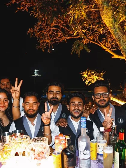 My team and I, all smiles behind the bar. We are a close-knit crew that works together to create a fun and professional bar experience.