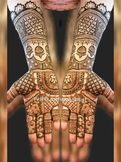 Symmetrical bridal hands with jhumka motifs and heavy jaali work. This is a classic look for a bride who loves traditional mehandi.