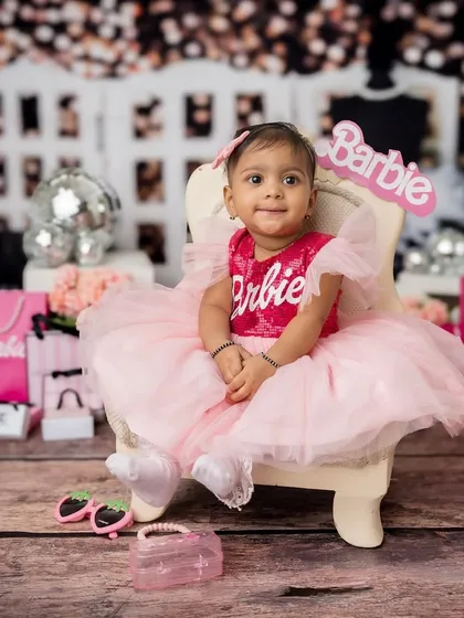 A beautiful portrait of the youngest sister in her Barbie-themed setup.