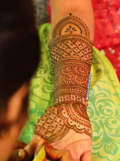 A shot of me applying a beautiful design on a bride. Your art is a reflection of your beauty.