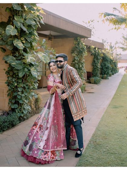 A playful and happy moment, with the groom whispering in the bride's ear, making her laugh.