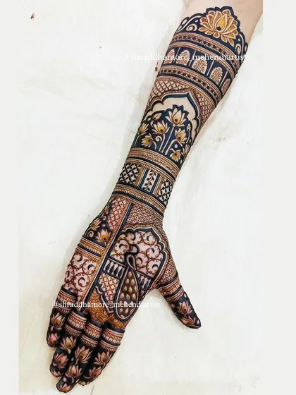 The other arm from the same bridal set, featuring a beautiful peacock and lotus motifs. The balance between filled and empty space creates a stunning visual effect.