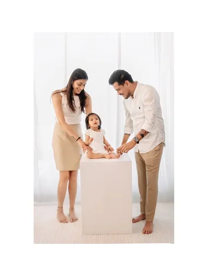 A sweet moment of parents doting on their little girl. Studio sessions provide a controlled environment to capture these gentle interactions perfectly.