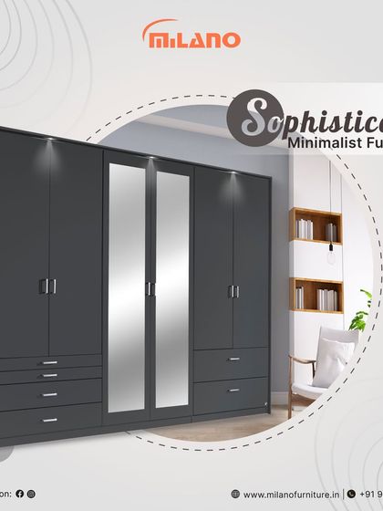 A sophisticated minimalist wardrobe in a dark grey finish with integrated lighting. This piece offers ample storage with a combination of hanging space, shelves, and drawers.