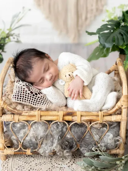 A classic newborn pose on a beautiful boho-style bed, complete with a tiny teddy bear for company. My focus is always on safe and comfortable posing for your baby.