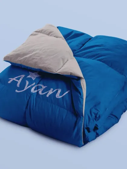 Introducing our quilted comforters, where style meets ultimate coziness. This blue one is personalised with a name and a star.