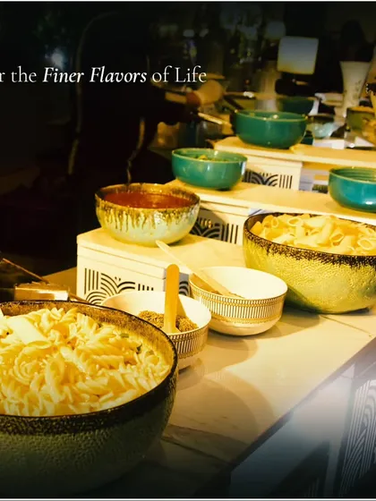 A pasta bar featuring different shapes of pasta and sauces in stylish bowls. We take pride in providing a wide array of culinary options to accommodate various event themes and styles.