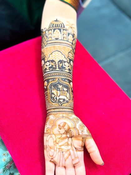 A side view of the custom bride-groom design, showing the layers of patterns on the forearm, including palace architecture and animal motifs.