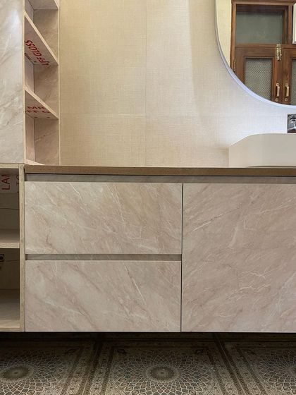A close-up of the floating vanity with its light marble finish and handleless drawers, contributing to the bathroom's clean and modern aesthetic.