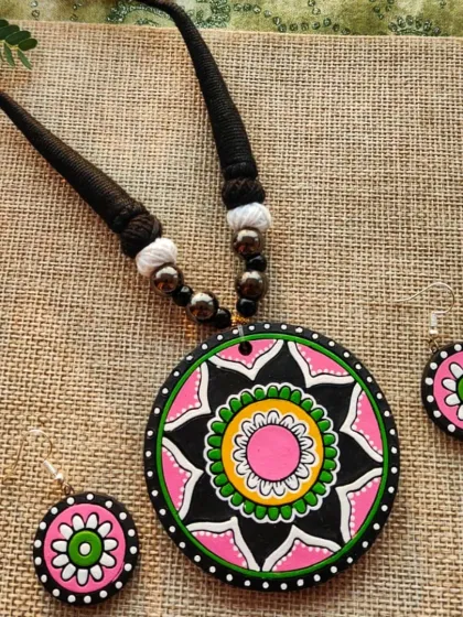 This version of the mandala pendant necklace is in a pretty pink, black, and green combination.