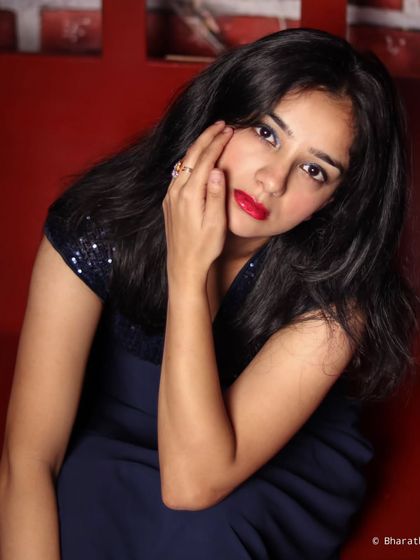 A close-up portrait that uses the red studio background to create a warm and intense mood, highlighting the subject's expression.