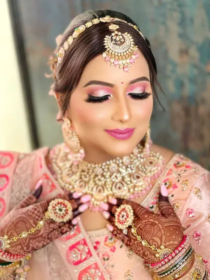A close-up focusing on the hathphool, a delicate hand ornament that connects the ring and bracelet, adding a traditional touch to her look.