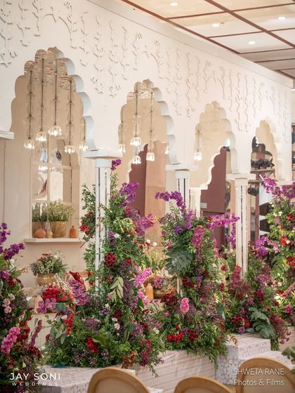 The intricate wall panels with traditional motifs serve as a stunning backdrop for the floral-filled lounge, where every detail contributes to the "Garden of Vows" theme.