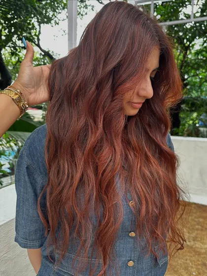 Holiday hair with a twist. This gorgeous reddish-copper color is perfect for making a statement on your next vacay. It’s warm, vibrant, and full of life.