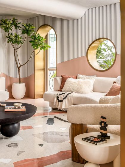 Another angle of the living room, showing the interplay of curved forms, textures, and natural light.