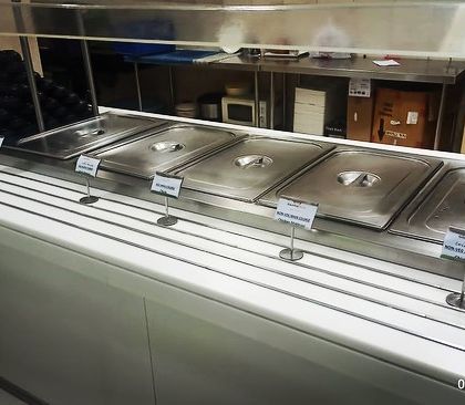 A clean and efficient buffet line setup for a corporate event in Sector 32, Gurgaon. The use of built-in counters ensures a seamless and professional look.