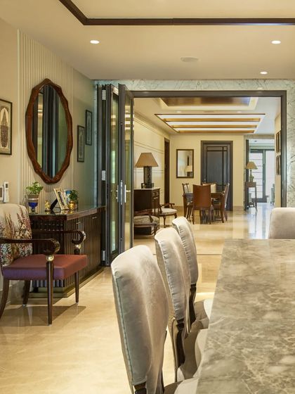 Another view showing the flow between spaces. The use of foldable doors and continuous marble flooring allows rooms to be either intimate or opened up into a larger, cohesive area.