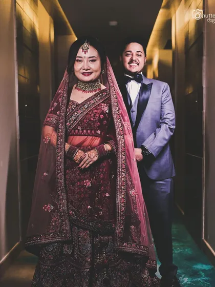 We have extensive experience capturing fusion weddings that blend different cultures. This portrait of an Indian-Malaysian couple showcases their unique style, combining a traditional lehenga with a modern tuxedo, reflecting their beautiful union.