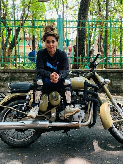 A graduate looks thoughtfully ahead, a picture of grace and power. She is in control of her journey.