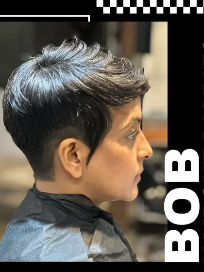 A profile view of a chic and edgy pixie bob haircut. This style highlights our ability to create sharp, modern looks with precise cutting and texturizing techniques for a low maintenance yet fashionable result.