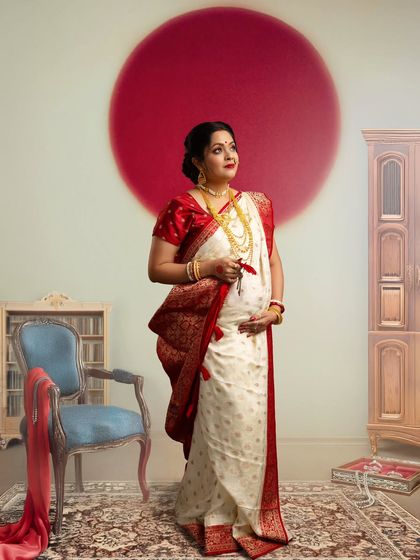 Celebrating Bengali heritage with a modern artistic touch. The prominent red bindi, or 'sindoor' mark, and the traditional white and red saree create a powerful and culturally significant portrait.