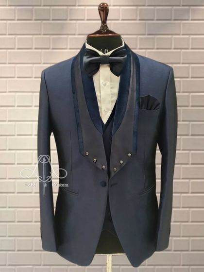A unique take on the tuxedo, this design features a double-bone collar in velvet. It's an innovative style for the groom who wants something truly different and impeccably tailored.