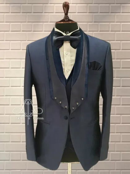 A double bone collar tuxedo designed for the immaculate groom. This unique design detail sets this navy blue tuxedo apart from the rest.
