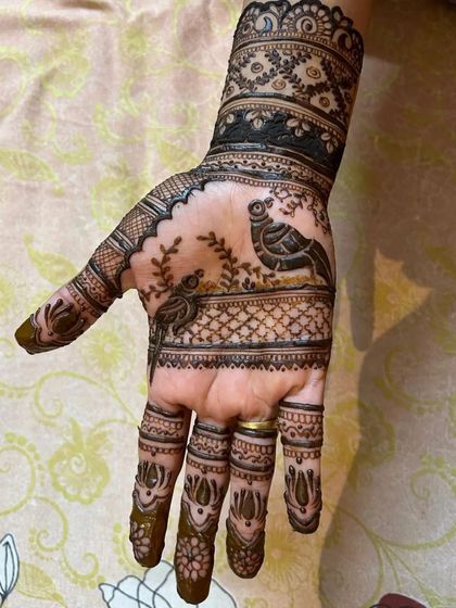 This traditional design features two birds perched within a scenic pattern. Learning to create symmetrical figures is a fun part of my advanced course.