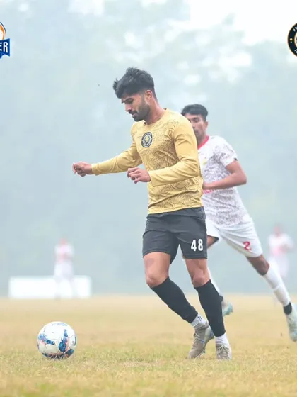 On the ball in a foggy match, our player demonstrates focus and control despite the challenging visibility.