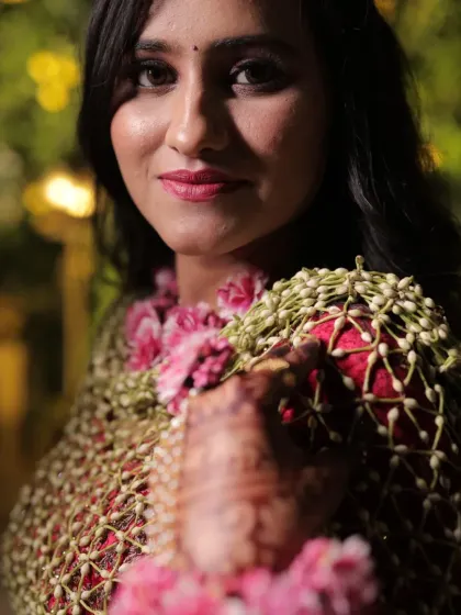 A close-up showing the texture of the hand-woven jasmine bud net and the rich red rose petal border. The craftsmanship in each shela is what makes it a true masterpiece.