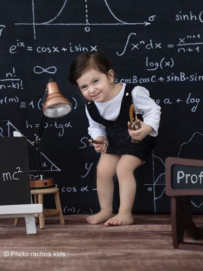 A mischievous smile from our little professor. These sessions are designed to be fun and engaging for toddlers.