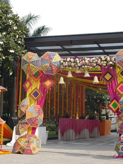 Welcome your guests with a burst of color and tradition. For this Mehendi, I created a vibrant entrance using Rajasthani patchwork umbrellas and marigold garlands, setting a joyful and festive tone from the very first step.