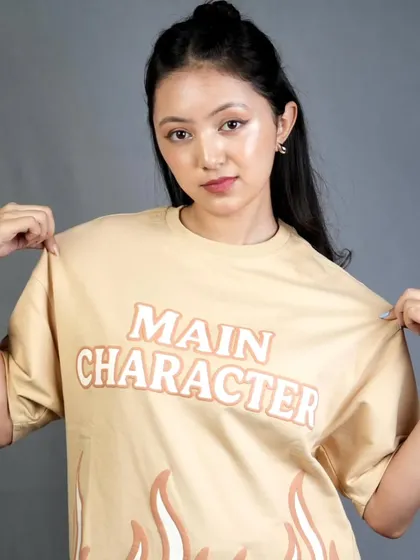 Another angle from the t-shirt shoot, showing how the natural makeup look appears fresh and authentic on camera. The simple hairstyle keeps the focus on the model's expression and the apparel.