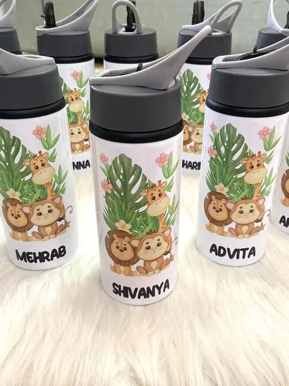 A collection of our jungle animal themed sipper bottles, personalised for a birthday party. These make for excellent and useful return gifts.